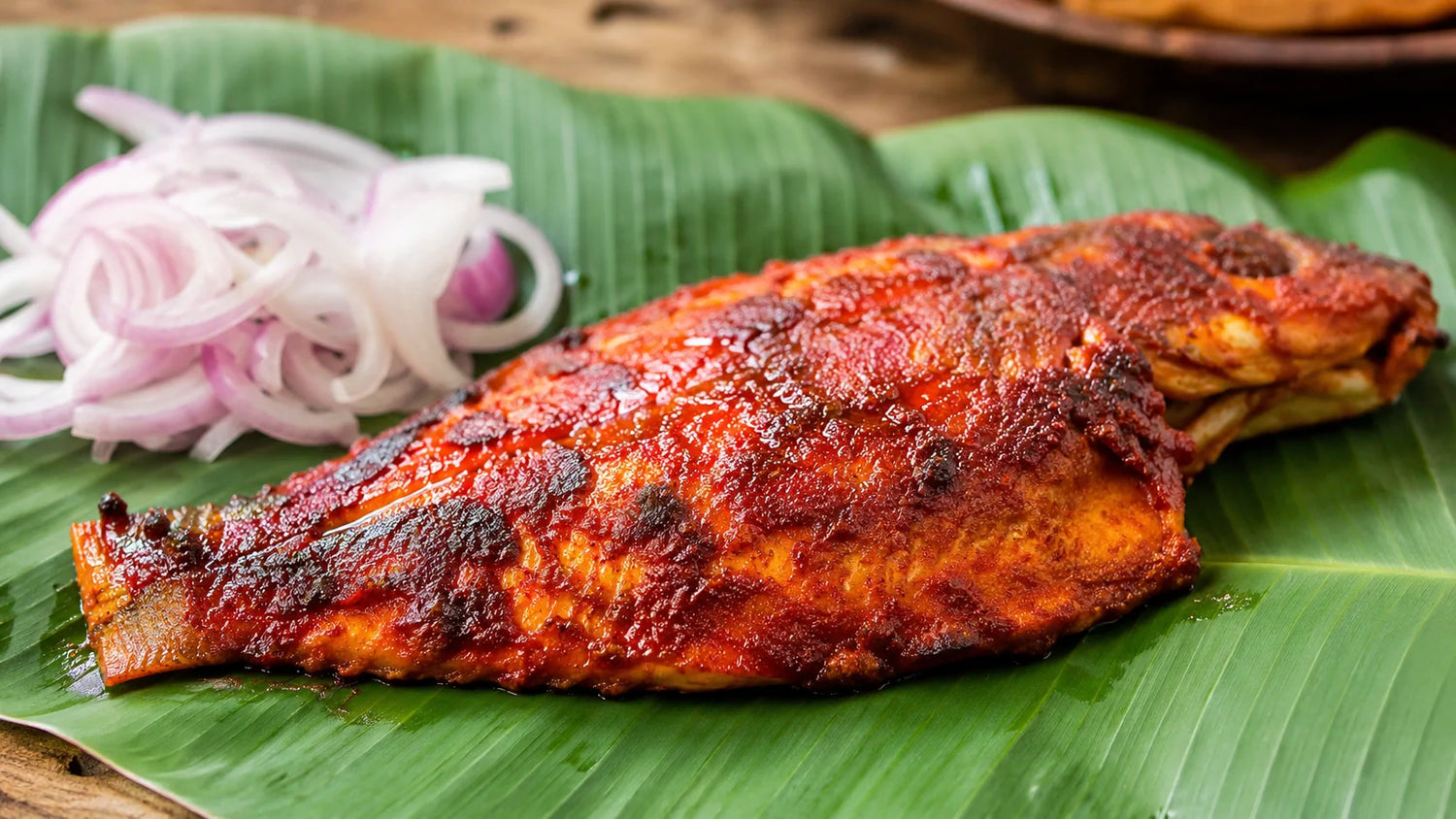 Fresh whole fish and pristine fillets resting on crushed ice with lemon slices.
