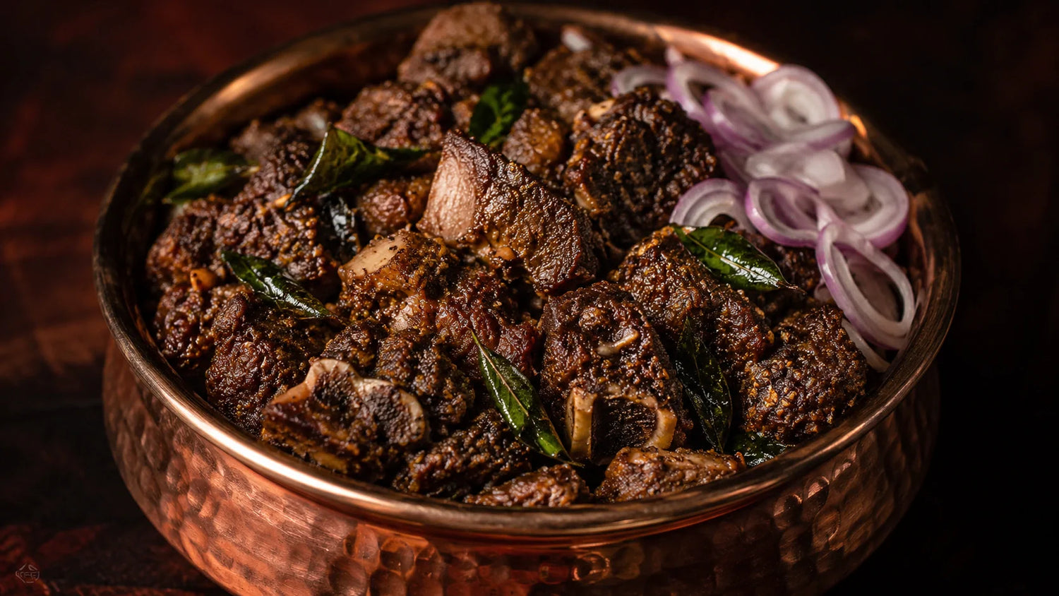 Fresh raw mutton cuts prepared on a rustic wooden board with spices.